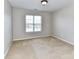 A neutral bedroom with a window allowing for plenty of natural light at 12907 Mccahan Ln, Huntersville, NC 28078