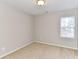 Neutral bedroom with a large window providing natural light and cozy carpeting at 12907 Mccahan Ln, Huntersville, NC 28078