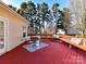 Relaxing deck area with seating and outdoor rug, perfect for entertaining and enjoying the serene wooded surroundings at 12907 Mccahan Ln, Huntersville, NC 28078