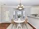 Dining nook featuring a chandelier, round table, bay window and tile backsplash at 12907 Mccahan Ln, Huntersville, NC 28078