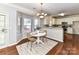 Cozy dining area with natural light, chandelier and breakfast bar overlooking kitchen at 12907 Mccahan Ln, Huntersville, NC 28078