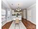 Dining room area with natural light and view into kitchen with breakfast bar at 12907 Mccahan Ln, Huntersville, NC 28078