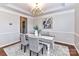 Elegant dining room with a chandelier, crown molding, and a view into the adjacent kitchen at 12907 Mccahan Ln, Huntersville, NC 28078