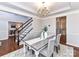 Elegant dining room with a chandelier, crown molding, and view into staircase and foyer at 12907 Mccahan Ln, Huntersville, NC 28078