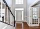 Welcoming foyer with hardwood floors and staircase, leading to a glass paneled office door at 12907 Mccahan Ln, Huntersville, NC 28078