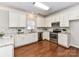 Bright kitchen features white cabinets, stainless steel appliances and granite countertops at 12907 Mccahan Ln, Huntersville, NC 28078