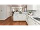 Kitchen featuring granite countertops, stainless steel sink, white cabinets and open floorplan at 12907 Mccahan Ln, Huntersville, NC 28078