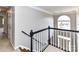 A charming staircase featuring traditional black and white elements leads to the upper level at 12907 Mccahan Ln, Huntersville, NC 28078