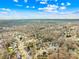 Expansive aerial view of a residential neighborhood with mature trees, showcasing the community's layout and green spaces at 13501 Misty Dew Ct # 19, Charlotte, NC 28273