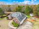 Aerial view of the home showcasing the brick exterior, shed, deck, landscaping, and long driveway at 13501 Misty Dew Ct # 19, Charlotte, NC 28273