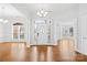 Spacious foyer with hardwood floors, decorative chandelier, and bright natural light through front door at 13501 Misty Dew Ct # 19, Charlotte, NC 28273