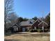 Beautiful single-story brick home with manicured front yard, dormer windows, and lush greenery offering great curb appeal at 13501 Misty Dew Ct # 19, Charlotte, NC 28273