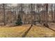 View of the backyard featuring a well and trees at 1412 Great Rd, Waxhaw, NC 28174