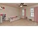 Bright bedroom with two windows featuring pink curtains and a ceiling fan at 1412 Great Rd, Waxhaw, NC 28174