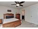 Bedroom features a wooden bed frame, ceiling fan, and ensuite bathroom access at 1412 Great Rd, Waxhaw, NC 28174