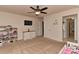 Bright bedroom with a ceiling fan, TV and a door to the ensuite bathroom at 1412 Great Rd, Waxhaw, NC 28174