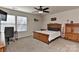 Comfortable bedroom features a ceiling fan, desk, and a wooden bed frame at 1412 Great Rd, Waxhaw, NC 28174