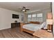 Bright bedroom with wooden furniture, ceiling fan, and large windows offering natural light at 1412 Great Rd, Waxhaw, NC 28174