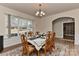 Bright dining area with a large window, showcasing a dining table set for a meal, perfect for Gathering dinners at 1412 Great Rd, Waxhaw, NC 28174