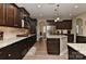 Bright kitchen boasts stainless steel appliances, granite countertops, and dark cabinets at 1412 Great Rd, Waxhaw, NC 28174