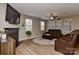 Cozy living room with ample windows, fireplace, and comfortable seating arrangement, ideal for relaxation at 1412 Great Rd, Waxhaw, NC 28174