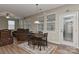 Inviting living room area features a wooden table and chairs, with natural light from a window at 1412 Great Rd, Waxhaw, NC 28174