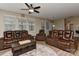 Bright living room with hardwood floors, ceiling fan, and plush leather seating providing comfort and style at 1412 Great Rd, Waxhaw, NC 28174