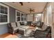 Relaxing screened-in sunroom with wicker furniture, ceiling fans, and wooded views at 1412 Great Rd, Waxhaw, NC 28174