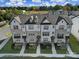 Aerial view of modern townhomes featuring detailed architectural design, manicured lawns, and community landscaping at 14139 Loyola Ridge Dr, Charlotte, NC 28277