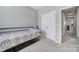 This bedroom features gray walls, light carpet, a metal frame bed, and a large closet at 14139 Loyola Ridge Dr, Charlotte, NC 28277