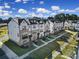 Eye-level aerial view of modern townhomes featuring a harmonious blend of brick and siding at 14139 Loyola Ridge Dr, Charlotte, NC 28277