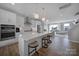 Bright kitchen features stainless steel appliances, white cabinetry and an island with bar seating at 14139 Loyola Ridge Dr, Charlotte, NC 28277