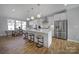 Open kitchen boasts an island with bar seating, stainless steel appliances and white cabinetry at 14139 Loyola Ridge Dr, Charlotte, NC 28277