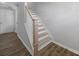 Staircase with wooden steps and white risers, seamlessly connecting different levels of the home at 14139 Loyola Ridge Dr, Charlotte, NC 28277