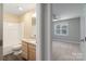 Well-lit bathroom features a shower-tub combo and a vanity with granite countertops at 14955 Alexander Place Dr, Huntersville, NC 28078