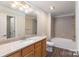 Light and airy bathroom featuring a shower over tub combo and granite vanity at 14955 Alexander Place Dr, Huntersville, NC 28078