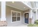 Covered front porch showing decorative door and architectural details at 14955 Alexander Place Dr, Huntersville, NC 28078