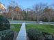 Landscaped front yard with a walkway leading to the home at 14955 Alexander Place Dr, Huntersville, NC 28078