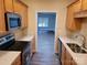 Kitchen with stainless steel appliances, light wood cabinets, and a granite countertop at 14955 Alexander Place Dr, Huntersville, NC 28078