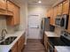 Kitchen featuring stainless steel appliances, light wood cabinets and a view into the living area at 14955 Alexander Place Dr, Huntersville, NC 28078