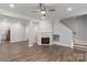 Open living area with fireplace, fan and staircase at 14955 Alexander Place Dr, Huntersville, NC 28078