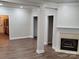 Open living area featuring hardwood floors, fireplace and kitchen views at 14955 Alexander Place Dr, Huntersville, NC 28078