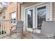 Relaxing balcony with comfortable seating, offering a view of the exterior of the building and glimpses of trees at 16436 Redstone Mountain Ln, Charlotte, NC 28277