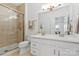 A beautifully tiled bathroom with a glass shower and dual sink vanity at 16436 Redstone Mountain Ln, Charlotte, NC 28277