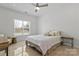 Bright bedroom features hardwood floors, a ceiling fan, and a sun-drenched window at 16436 Redstone Mountain Ln, Charlotte, NC 28277