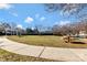 Community area with outdoor seating, picnic tables, and mature shade trees at 16436 Redstone Mountain Ln, Charlotte, NC 28277