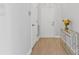 Bright entryway features wood floors and a mirrored console table with flowers at 16436 Redstone Mountain Ln, Charlotte, NC 28277