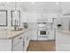 White kitchen featuring stainless steel faucet, oven, and stainless steel appliances at 16436 Redstone Mountain Ln, Charlotte, NC 28277