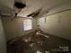 Bedroom with ceiling damage and debris on the floor at 169 Adams Cir, Candor, NC 27229