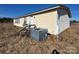 Side view of mobile home showing AC unit and deck at 169 Adams Cir, Candor, NC 27229